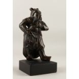 A GOOD 19TH CENTURY CHINESE BRONZE FIGURE OF GUANDI, with his hand on his beard and modeled stood on