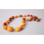 A GOOD SET OF CHINESE AMBER OVAL BEAD ROSARY / NECKLACE, of graduating sizes, 50cm overall.