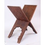 AN ISLAMIC CARVED WOOD FOLDING KORAN STAND.