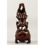 A GOOD 19TH CENTURY CHINESE CARVED BAMBOO FIGURE OF GYMNAST, doing a handstand upon a stylized toad,