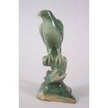 A CHINESE JADEITE CARVING OF A BIRD, the bird modelled stood on the stump of a tree, qianlong style,