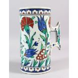 A 19TH CENTURY IZNIK STYLE POTTERY TANKARD, the sides with blue ground and flower heads, cockerel