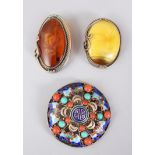 AN ENAMEL TORTOISESHELL AND CORAL BROOCH and two other brooches.