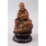 A 19TH CENTURY CHINESE CARVED SOAPSTONE FIGURE OF LUOHAN & STAND, seated upon carved stylized clouds