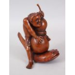 A GOOD JAPANESE MEIJI PERIOD CARVED WOOD OKIMONO OF A MAN & CATFISH, the man rendered holding his