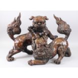A LARGE JAPANESE MEIJI PERIOD BRONZE OKIMONO GROUP OF SHI SHI DOGS, the large dogs modeled fighting;