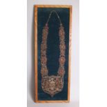 AN INDIAN GILT THREAD CHAIN OF OFFICE 'PROREGEETPATRIA' on a felt background, 90cm x 30cm, framed.