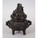 A 20TH CENTURY CHINESE BRONZE TRIPOD CENSER + COVER, the censer with moulded panels of dragons and