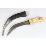 A 19TH CENTURY PERSIAN QAJAR MARINE IVORY HILTED DAGGER with circular watered-steel blade, the