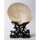 A 19TH CENTURY CHINESE CARVED ABALONE SHELL ON STAND, carved with village scenes, together with a