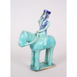 A RARE 12TH-13TH CENTURY PERSIAN KASHAN POTTERY TURQUOISE GLAZED EQUESTRIAN FIGURE on a flat base.