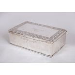 A GOOD ISLAMIC SILVER RECTANGULAR BOX with calligraphy dated 1919, 13cm long, 8cm wide, 4cm high.