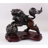 A 19TH CENTURY CHINESE BRONZE FIGURE OF A LION DOG & BALL, the lion dog with its front paws upon the