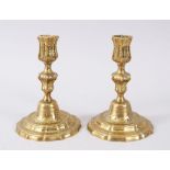A GOOD PAIR OF CAST BRASS CANDLESTICKS with engraved decoration, 17cm high.