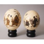 A GOOD PAIR OF JAPANESE MEIJI PERIOD GOLD LACQUERED OSTRICH EGGS ON STANDS, the eggs finely