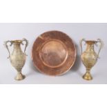 AN EARLY INDIAN BRASS CHARGER with calligraphy, 39cm diameter and a pair of two handled vases,