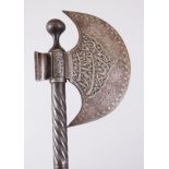 A 19TH CENTURY ISLAMIC PERSIAN HAND CHISLED STEEL INLAID AXE, 74cm long.