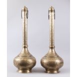 A GOOD PAIR OF 19TH CENTURY PERSIAN QAJAR HAND CHASED BRASS TALL BOTTLE VASES