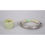 A GOOD CHINESE JADE ARCHERS RING + A CHINESE JADE SILVER MOUNTED BRACELET, the ring measuring 3.