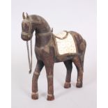 AN ISLAMIC CARVED WOOD HORSE with bone saddle, 20cm high.