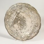 AN EARLY 20TH CENTURY BURMESE WHITE METAL DISH, decorated with various roundel's with impressed