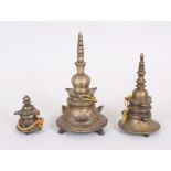 THREE ISLAMIC BRONZE TOWERS, 20cm, 16cm and 8cm.