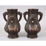 A PAIR OF 20TH CENTURY CHINESE BRONZE CLOISONNE VASES, the vases with formed lion dog handles, the