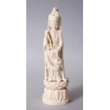 A JAPANESE MEIJI PERIOD CARVED IVORY OKIMONO OF KWANNON, she is modelled stood upon a lotus base