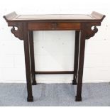 A GOOD TALL CHINESE HARDWOOD ALTER TABLE, with scroll ends, and a plain frieze with a carved symbol,