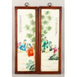 A GOOD PAIR OF CHINESE FAMILLE ROSE PORCELAIN PANELS IN HARDWOOD FRAMES, each picture depicting