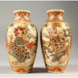 A PAIR OF JAPANESE MEIJI PERIOD SATSUMA VASES, decorated with panels of immortals interior