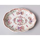 AN 18TH CENTURY CHINESE FAMILLE ROSE PORCELAIN SPOON TRAY,decorated with scenes of flora, 12.5cm x
