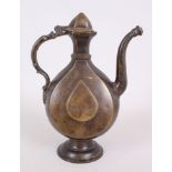 A 17TH-18TH CENTURY INDIAN BRONZE EWER with calligraphy, 30cm high.