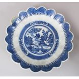 A 19TH CENTURY CHINESE BLUE & WHITE PORCELAIN SCALLOPED DISH, decorated with central scenes of a