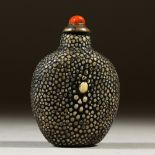A 19TH CENTURY CHINESE SHAGREEN SNUFF BOTTLE, with coral stopper,6 cm high x 4.1cm wide.