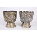 A PAIR OF POSSIBLY MAMLUK BRASS FOOTED CIRCULAR BOWLS with engraved decoration, 13cm high, 12cm
