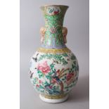 A 19TH CENTURY CHINESE FAMILLE ROSE PORCELAIN BOTTLE VASE, with twin elephant head handles, the body