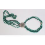 A LONG JADE AND SILVER FIVE STRAND NECKLACE.
