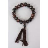 A GOOD CHINESE CHERRY AMBER BRACELET / NECKLACE, comprising of 21 spherical beads of assorted sizes,