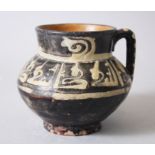 A 9TH-10TH CENTURY PERSIAN NISHAPUR POTTERY JUG with calligraphy, 12cm high.
