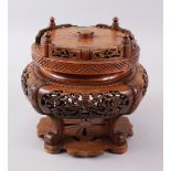 A CHINESE 19TH CENTURY CARVED AND PIERCED HARD WOOD ROTATING STAND, the sides carved and pierced