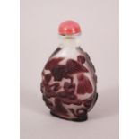 A GOOD CHINESE GLASS OVERLAY SNUFF BOTTLE, the decoration depicting birds amongst trees, the pink