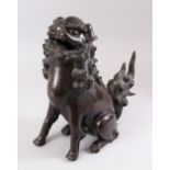 A 19TH CENTURY CHINESE BRONZE LION DOG CENSOR, the dog in a seated position with his head aloft