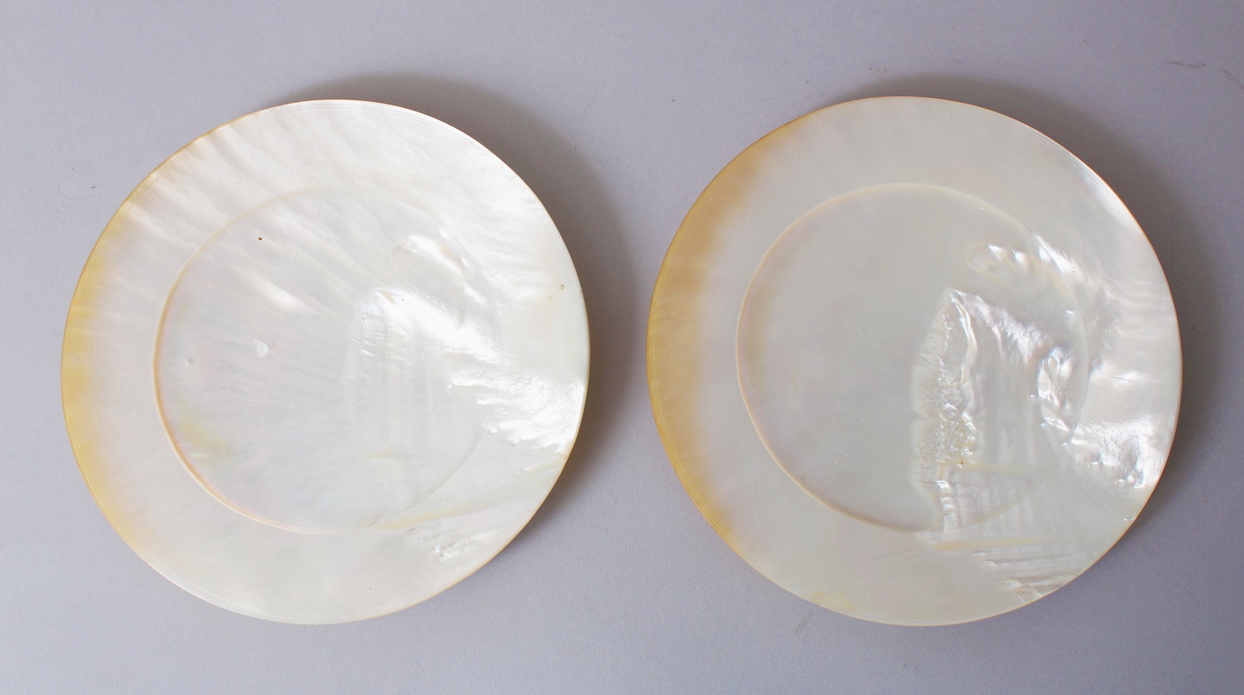 TWO 19TH CENTURY CHINESE MOTHER OF PEARL / ABALONE PLATES, 16.3cm diameter.