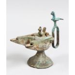 A 12TH CENTURY SELJUK BRONZE OIL LAMP with two bird finials, 12cm high.