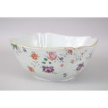 AN UNUSUAL 18TH CENTURY CHINESE FAMILLE ROSE PORCELAIN BOWL, the simple decoration depicting florets