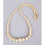 A VERY LONG WORKED IVORY GRADUATED NECKLACE, 120cm long.