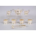 AN ASIAN SILVER TWO HANDLED CIRCULAR BOWL AND COVER, SIX CUP HOLDERS and a pair of sugar tongs.