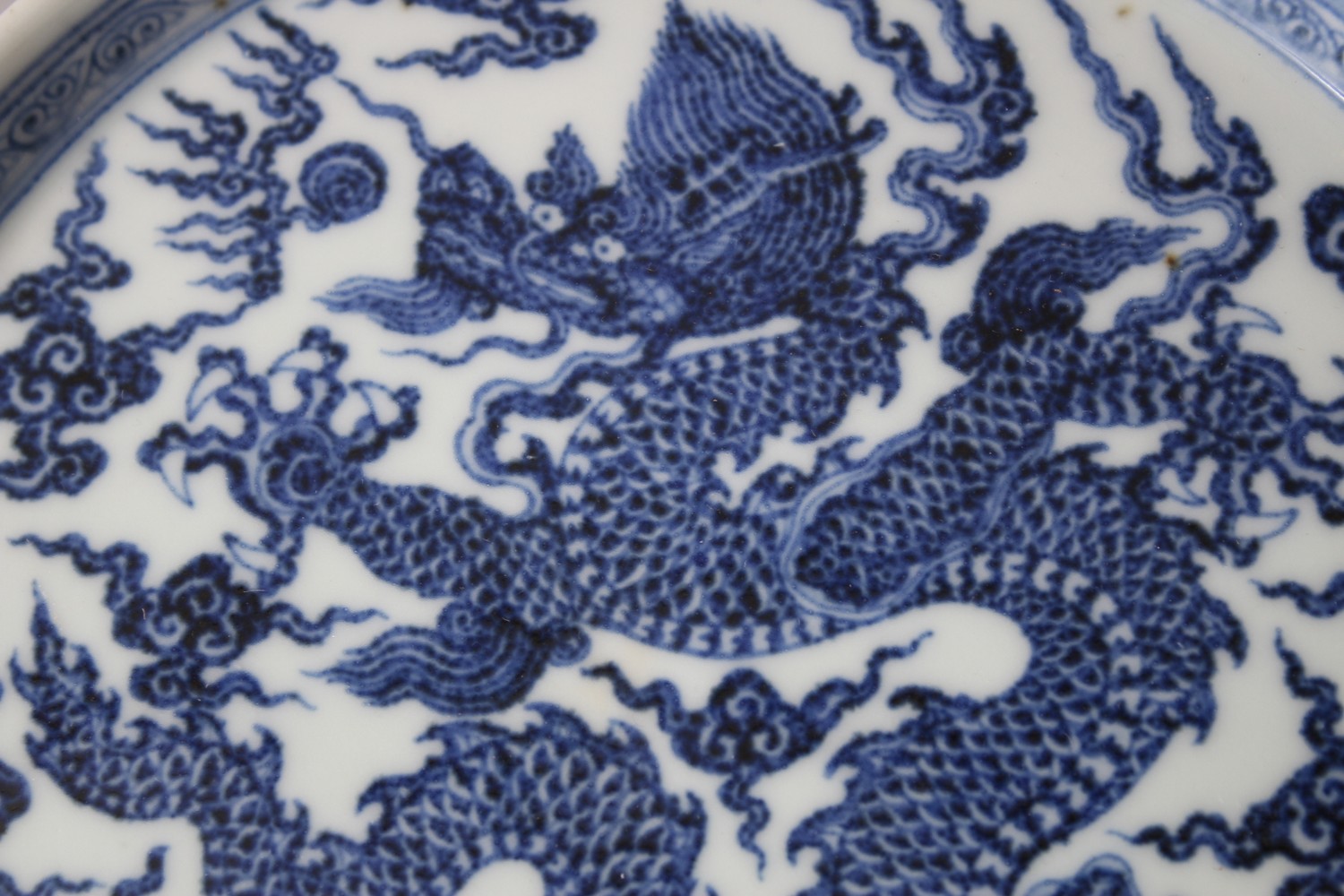 A CHINESE MING STYLE BLUE & WHITE PORCELAIN DRAGON PLATE, dragon amongst stylized clouds, the base - Image 2 of 4