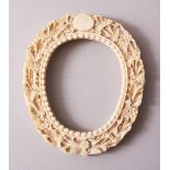 A 19TH CENTURY CHINESE CANTONESE CARVED IVORY FRAME OF OVAL FORM, carved in deep relief with